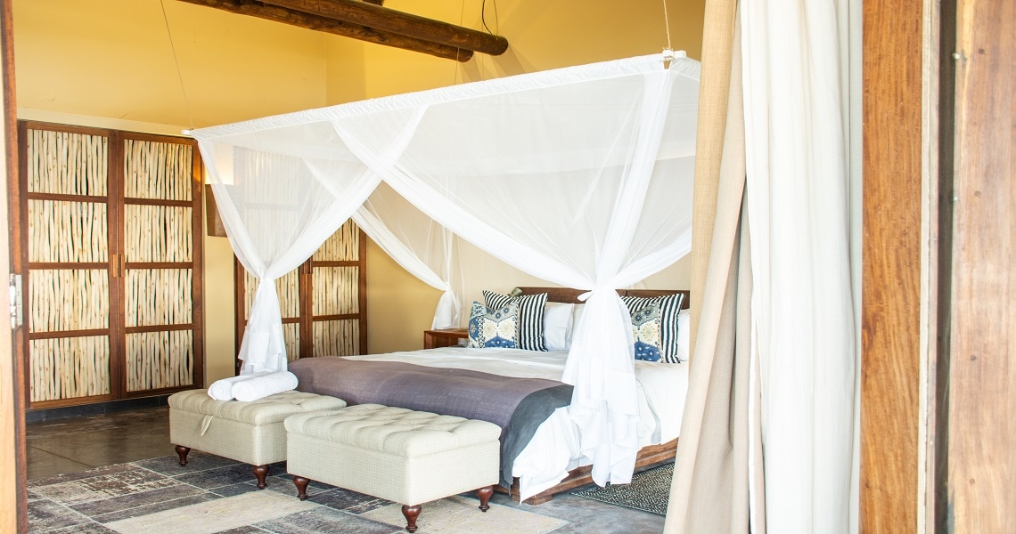 Luxury suite with a king-size bed that's covered with a mosquito net